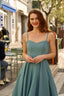 A redhead in Cannes wearing a sunhat and a blue cotton/linen Gaâla Bardot dress, playfully lifting up the skirt to show a voluminous petticoat underneath.